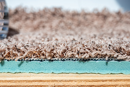 green rug pad attached to a rug