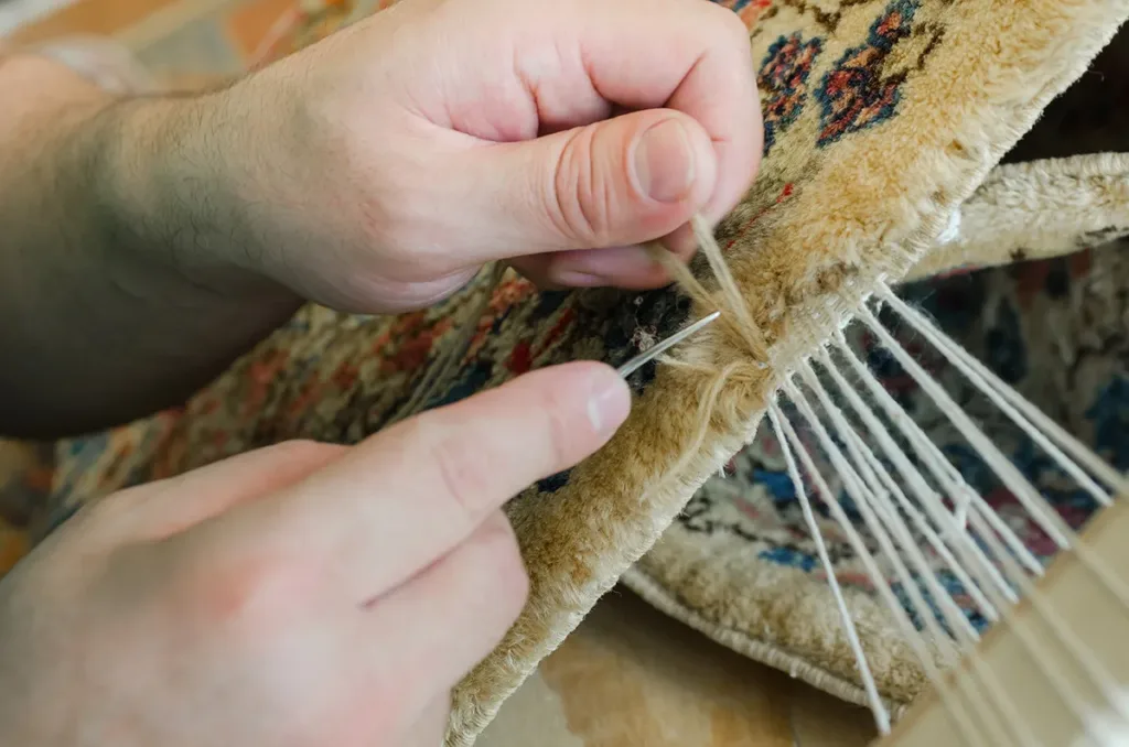 Professional worker repairing rug